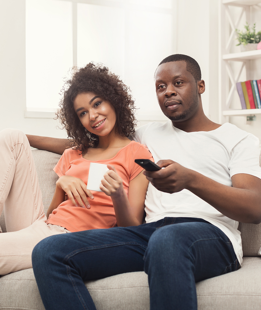Image of a couple watching TV at home