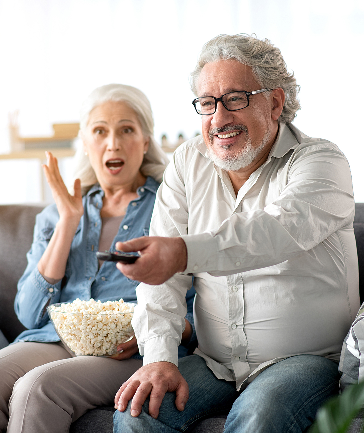 Image of mature married couple watching TV together